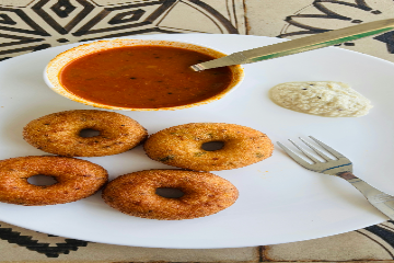 Vada is a savory, deep-fried Indian snack that can be described as a fritter, cutlet, or dumpling. Vadas are typically made from lentils, herbs, and spices, and are often served with chutneys and sambar.